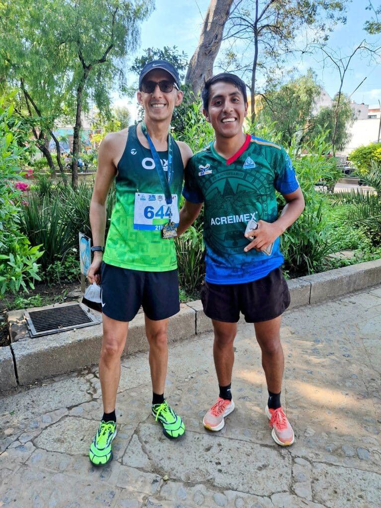 Fahad Hizam after Acreimex 21k with Juan Victoria, wearing his finisher medal and bib 644.