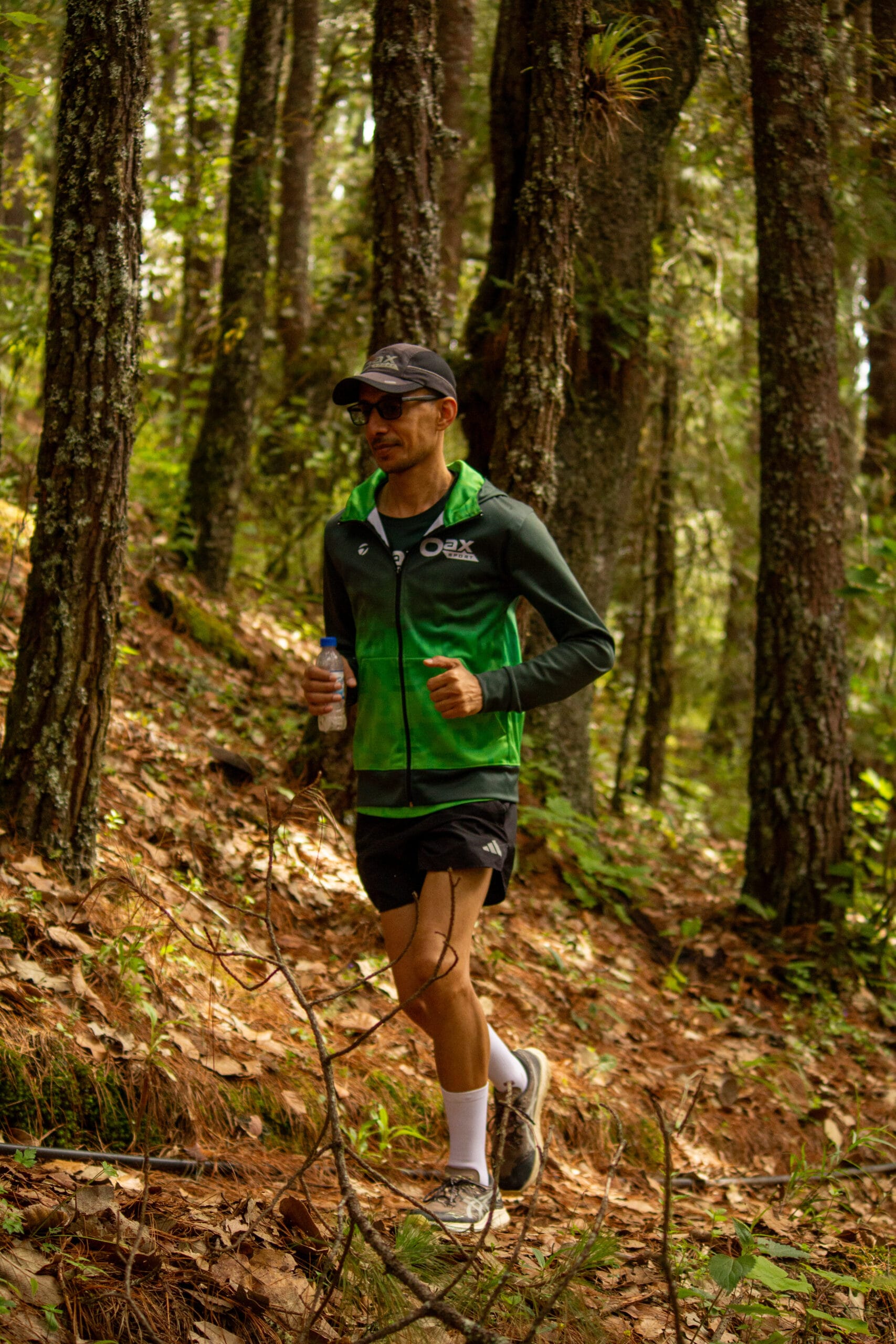 Fahad Hizam trail running in the pine forest above Oaxaca